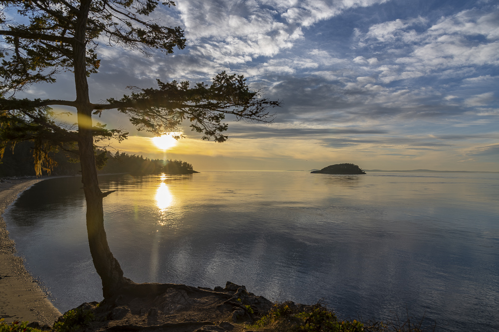 A beautiful sunset at Deception Pass State Park looking out at the Salish Sea, Straight of Juan de Fuca, Whidbey Island, Washington.