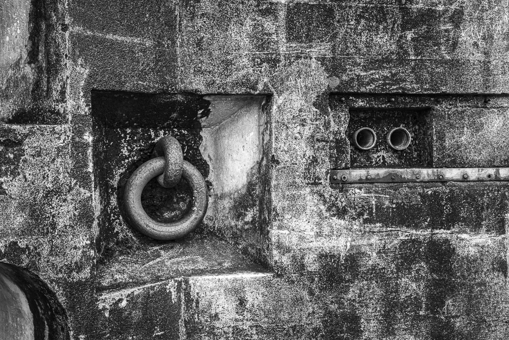 Monochrome detail and textures of historic battlement mooring ring