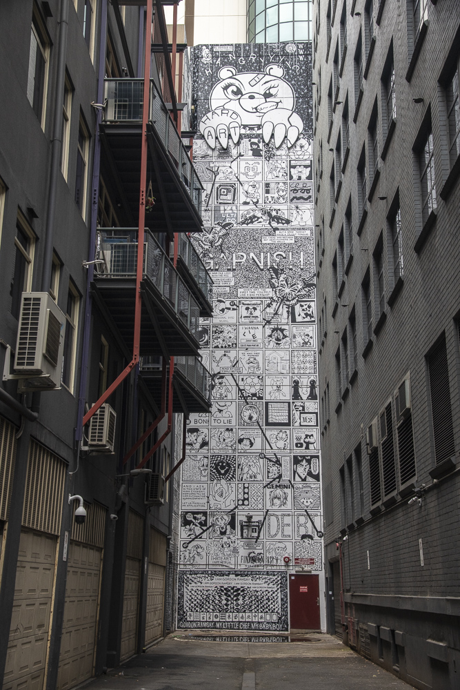 An amazing wall of street art at the end of an Alley called Crown Place in central Melbourne, Victoria, Australia.  The mural was produced by many people crediting themselves as "Bootleg Comics".
