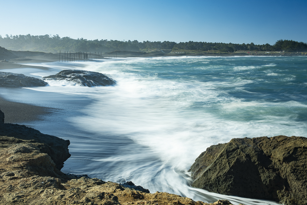 Waves softened by a long exposure surge onto the beach at MacKerricher State Park and Marine Conservation Area near Cleone in Northern California