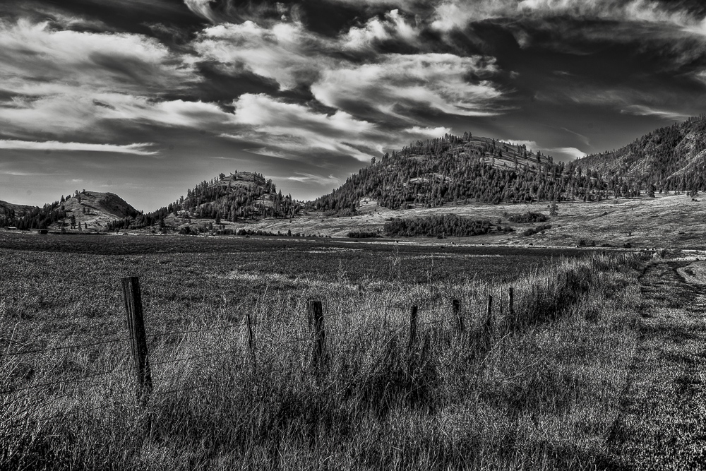 Black and White of framatic clouds, fields and rolling hills near Conconully, Eastern Washington