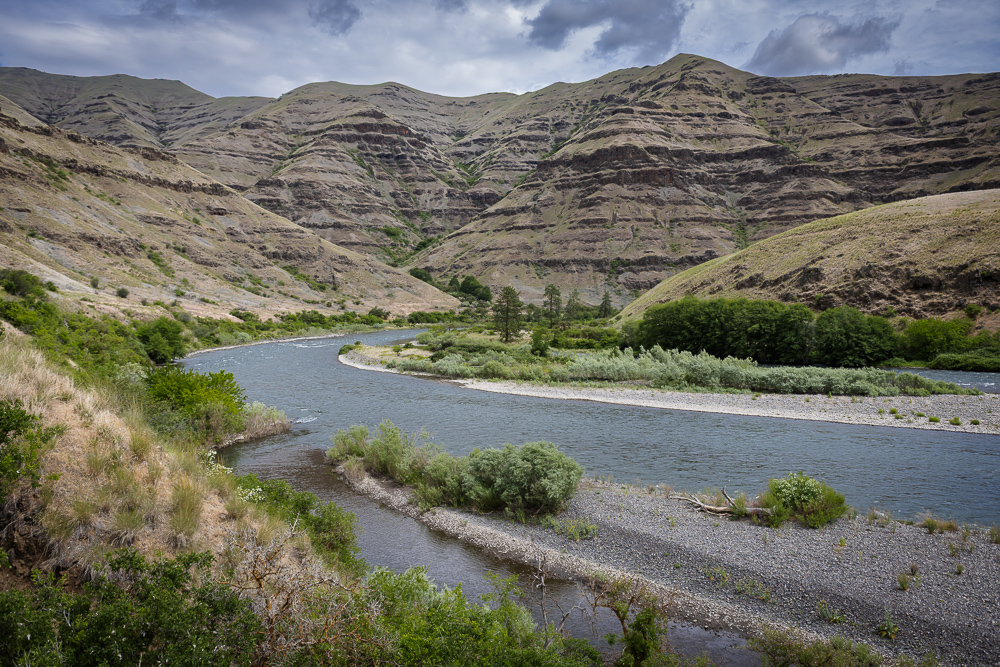 The gravel bars, the exposed geologic and eroding cliffs of the wild Snake River as seen from the Washington side looking across to the Idaho side.