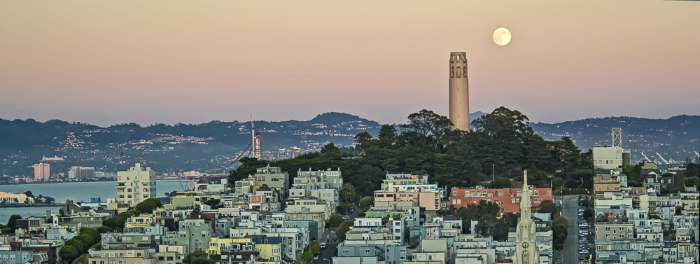 Panorama of the full Moon rising behind the Coit Tower on Telegraph Hill, San Francisco, California