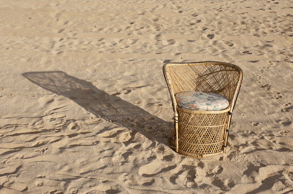 Wicker with shadow on sand, Kauai, Hawaii