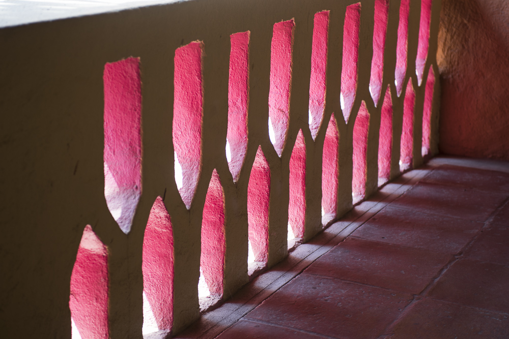 Light and shadow through a pink painted stucco wall, Mexico