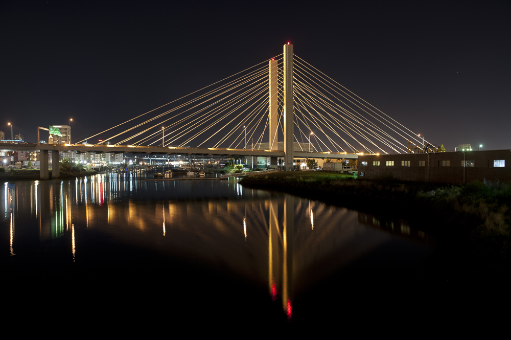 East 21th street (SR509) suspension bridge reflecting on the Foss Waterway at night, Tacoma, Washington