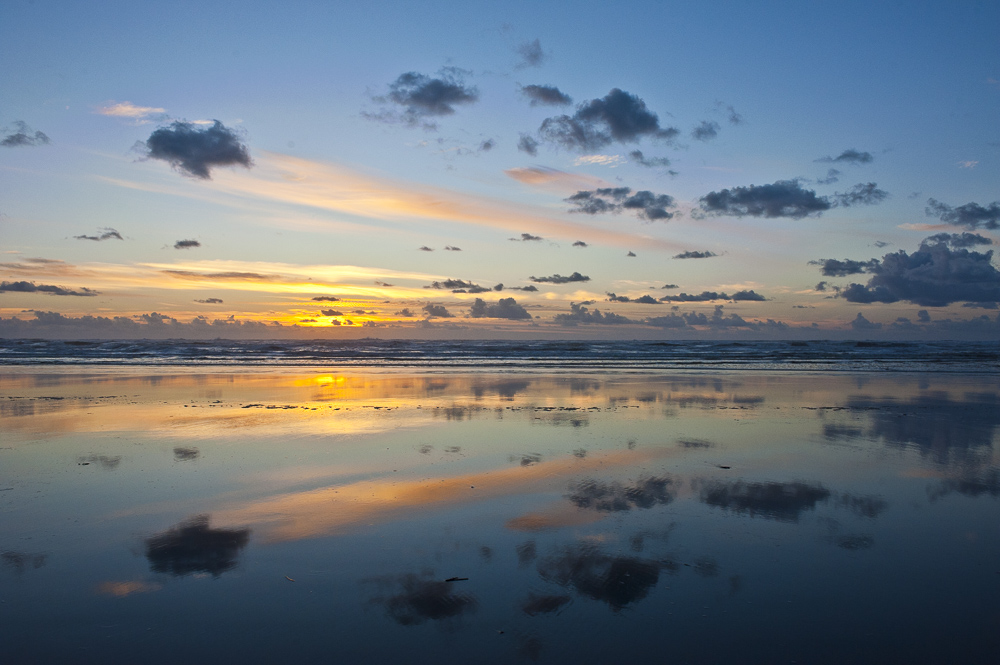 Fall Sunset and clouds  reflection on the beach at Ocean Shores, Washington